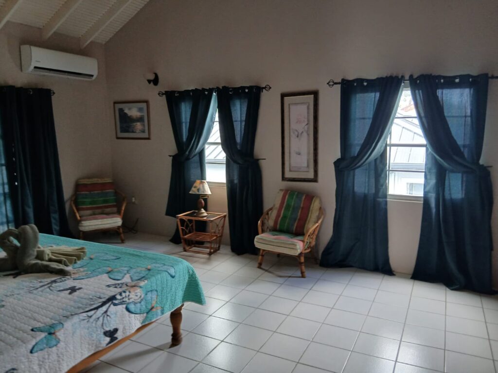 Bona Villa, Bon Accord, Tobago: the master suite, with a vaulted ceiling and a seating corner.