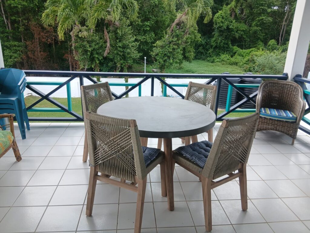Bona Villa, Bon Accord, Tobago: the upstairs verandah dining table, overlooking the trees.